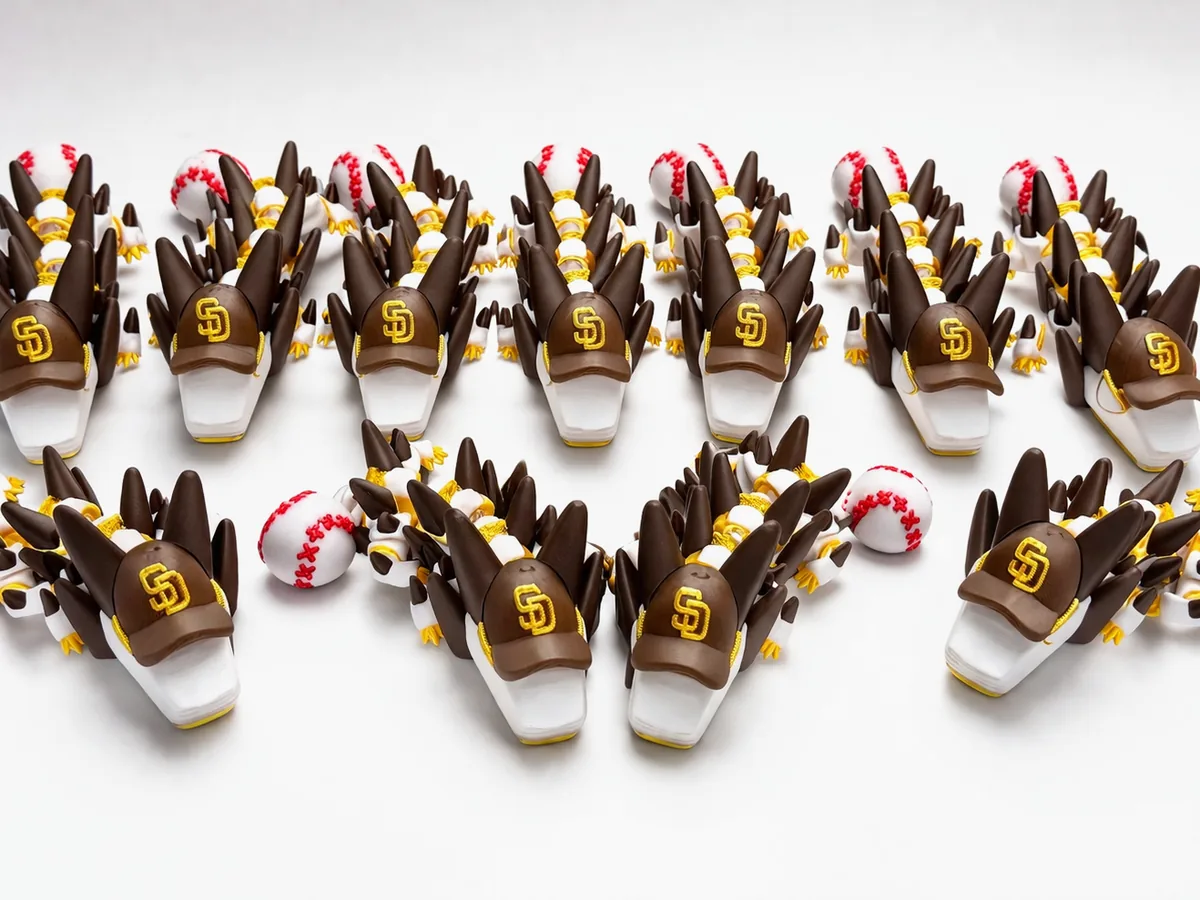 A row of printed dragon figures ready to ship